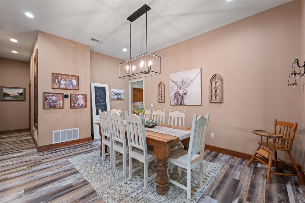 290 Barton Road Maypearl, TX 76064 - Photo 8 of 34 a view of a dining room with furniture wooden floor and chandelier