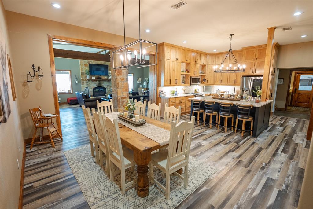 290 Barton Road Maypearl, TX 76064 - Photo 9 of 32 a view of a dining room with furniture window and wooden floor