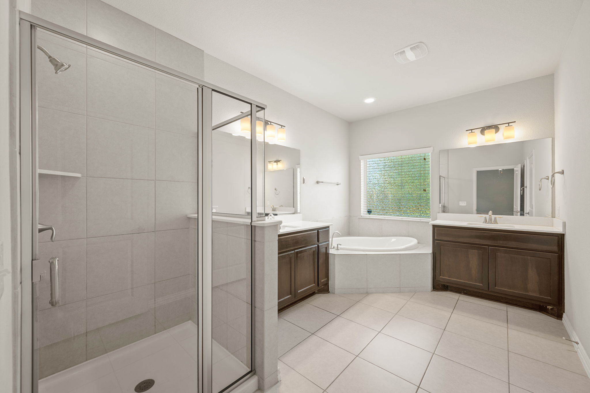 8800 Slater Drive Austin, TX 78747 - Photo 18 of 40 a large bathroom with a tub sink shower and mirror