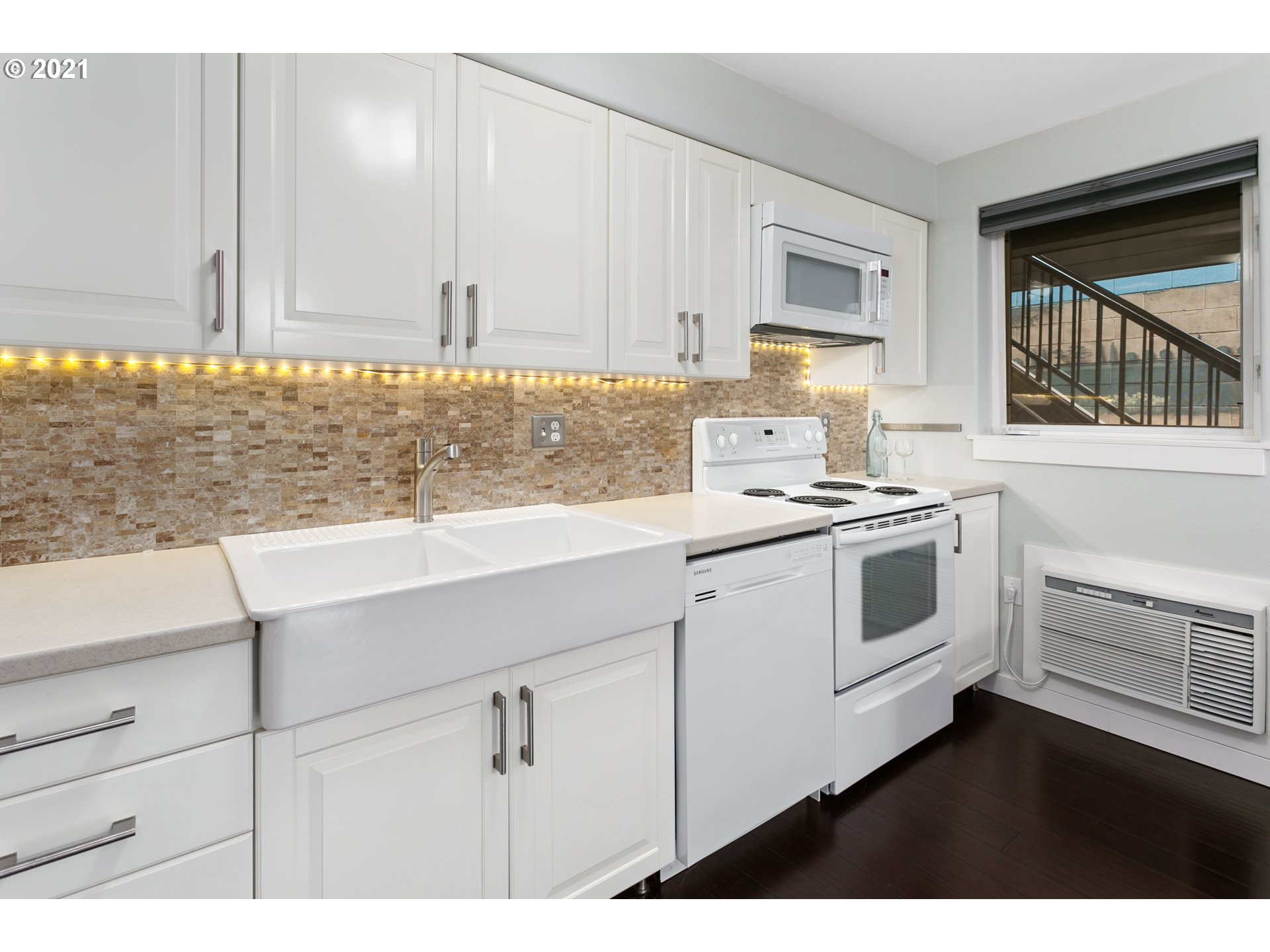 10345 Northeast Clackamas Street, Unit 2 Portland, OR 97220 - Photo 11 of 28 a kitchen with granite countertop white cabinets and white appliances