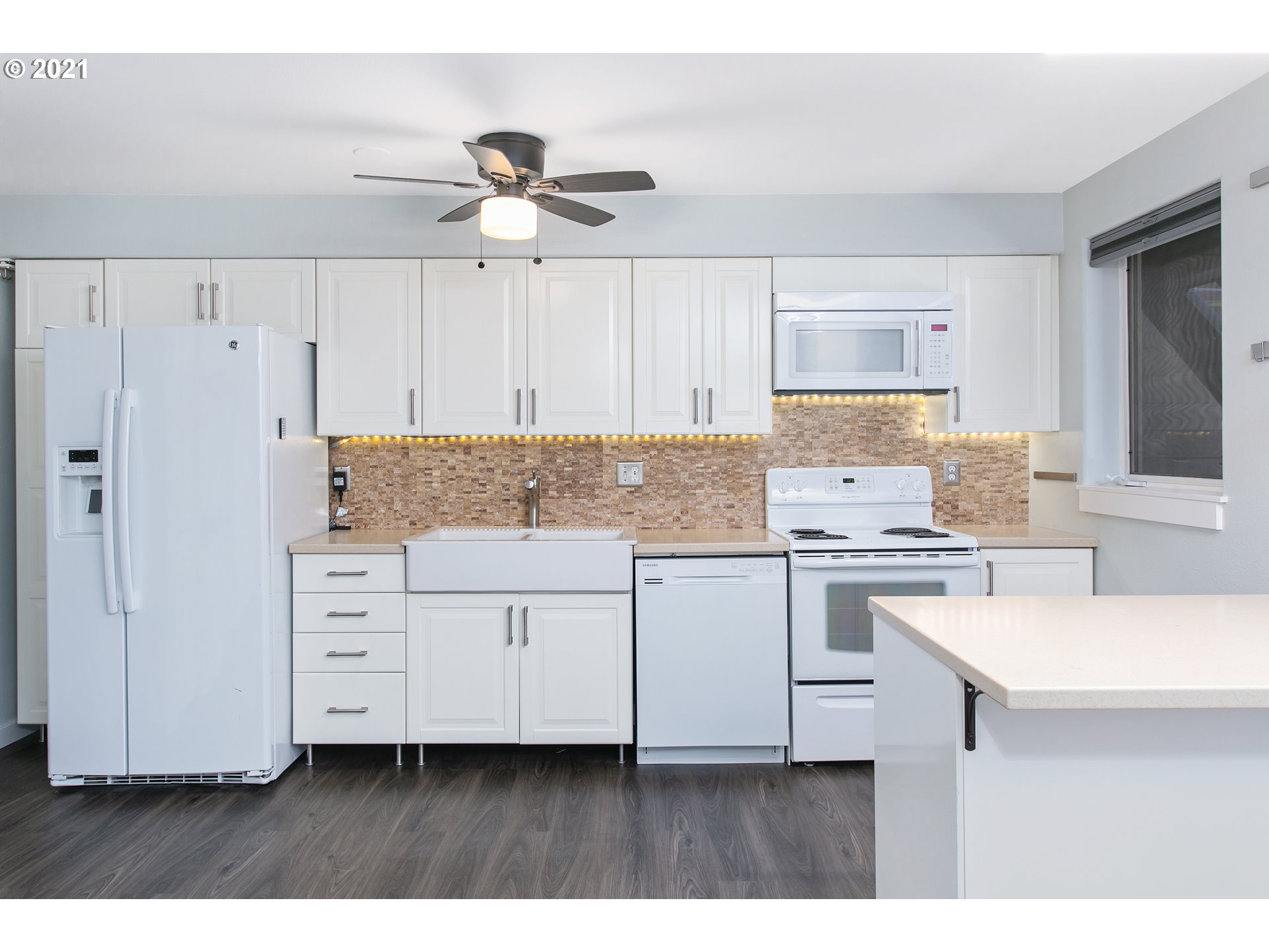 10345 Northeast Clackamas Street, Unit 2 Portland, OR 97220 - Photo 12 of 28 a kitchen with cabinets appliances a sink and a counter top space