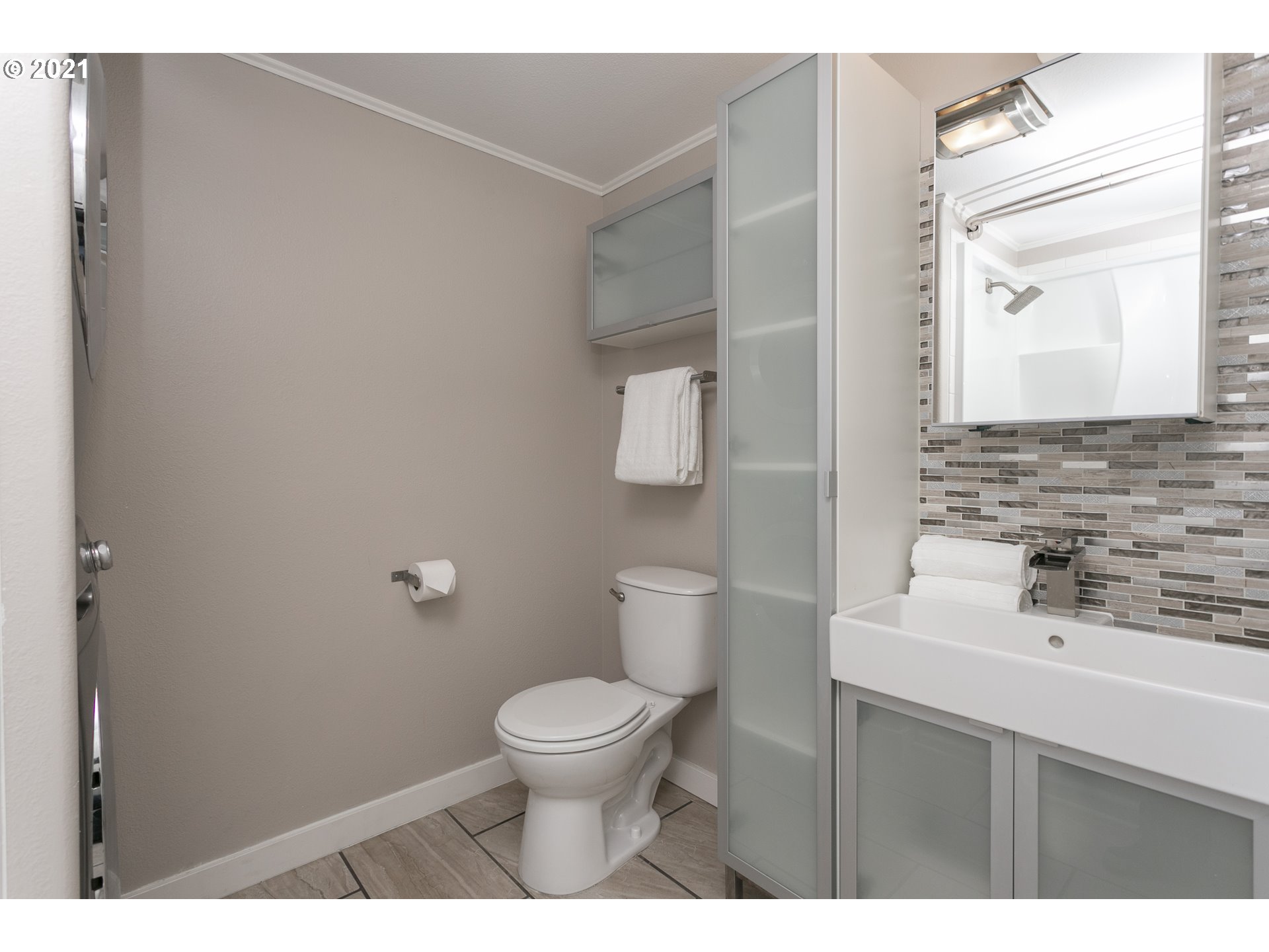 10345 Northeast Clackamas Street, Unit 2 Portland, OR 97220 - Photo 20 of 28 a bathroom with a sink toilet and mirror