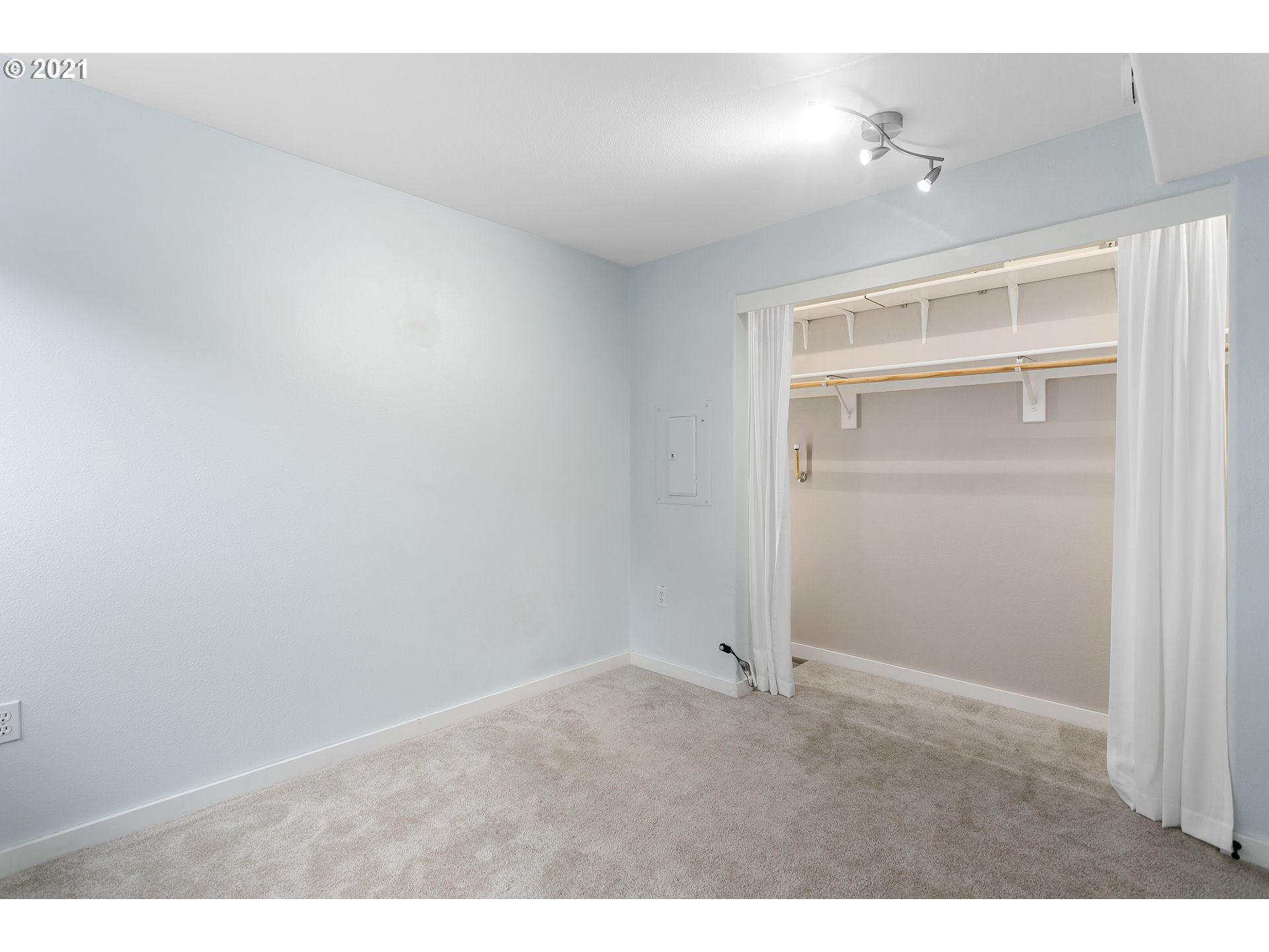10345 Northeast Clackamas Street, Unit 2 Portland, OR 97220 - Photo 22 of 28 an empty room with closet and windows