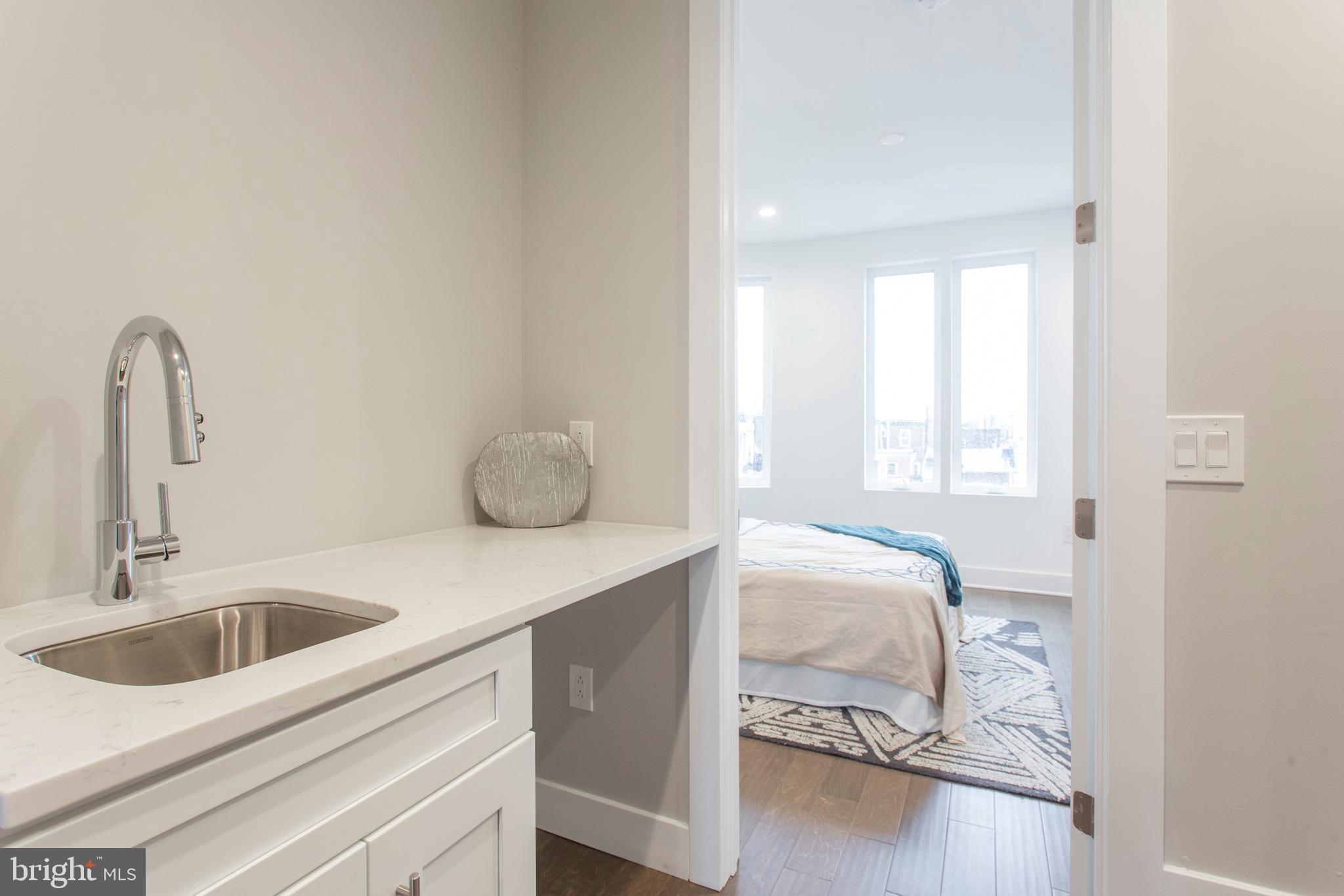 542 Pierce Street Philadelphia, PA 19148 - Photo 20 of 36 a bedroom with a bed and a sink