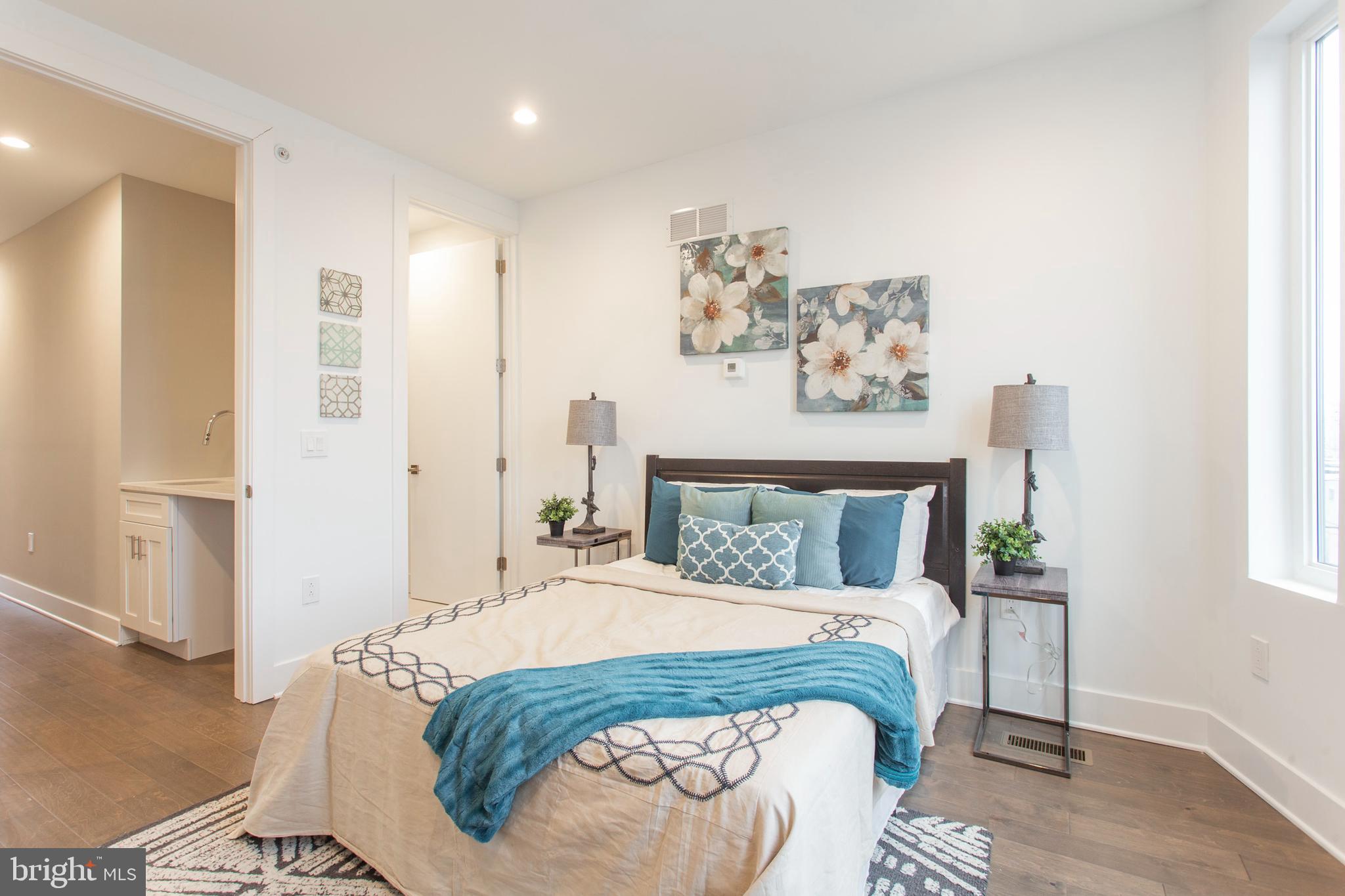 542 Pierce Street Philadelphia, PA 19148 - Photo 21 of 36 a bedroom with a large bed and a window