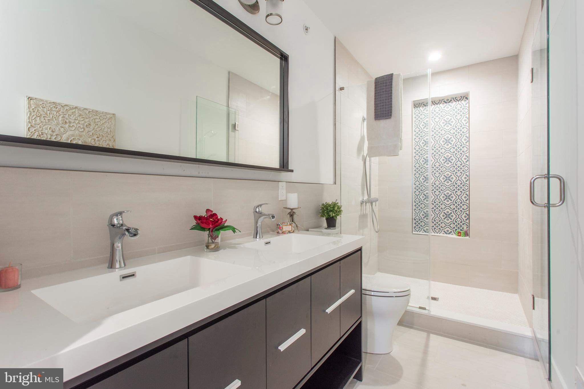 542 Pierce Street Philadelphia, PA 19148 - Photo 24 of 36 a bathroom with a sink and a mirror