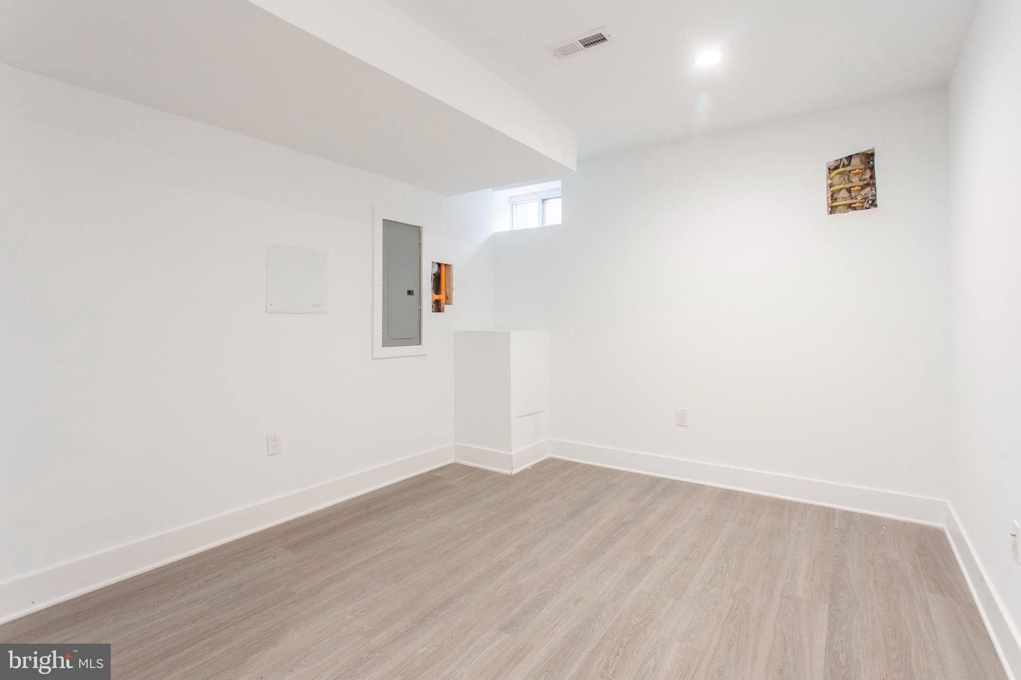 542 Pierce Street Philadelphia, PA 19148 - Photo 29 of 36 a view of a room with wooden floor and white walls