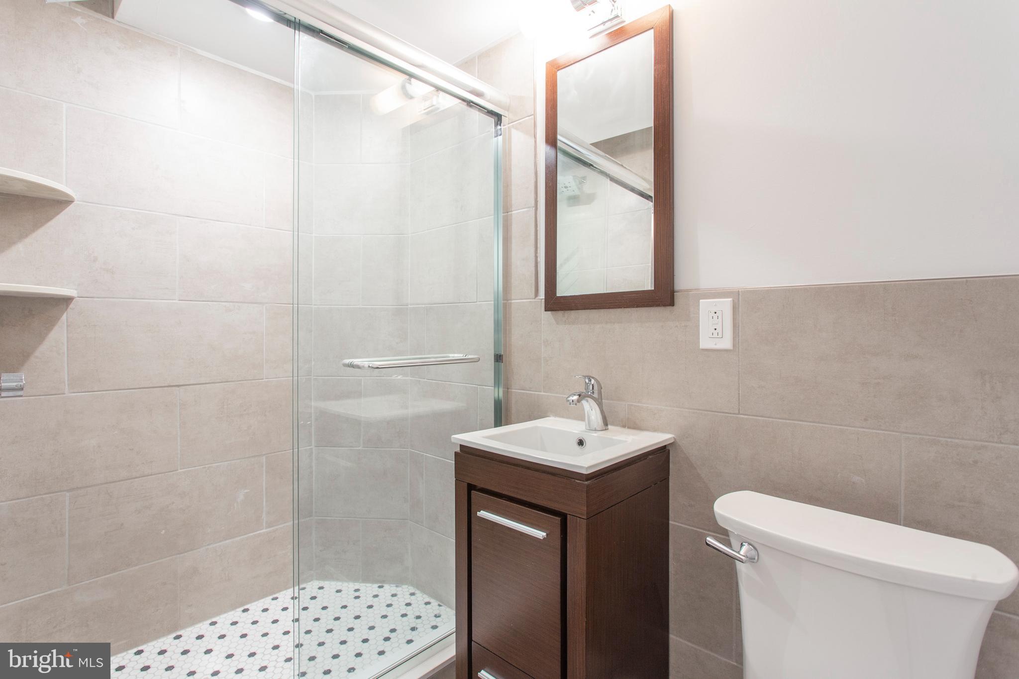 542 Pierce Street Philadelphia, PA 19148 - Photo 30 of 36 a bathroom with a sink a toilet and shower