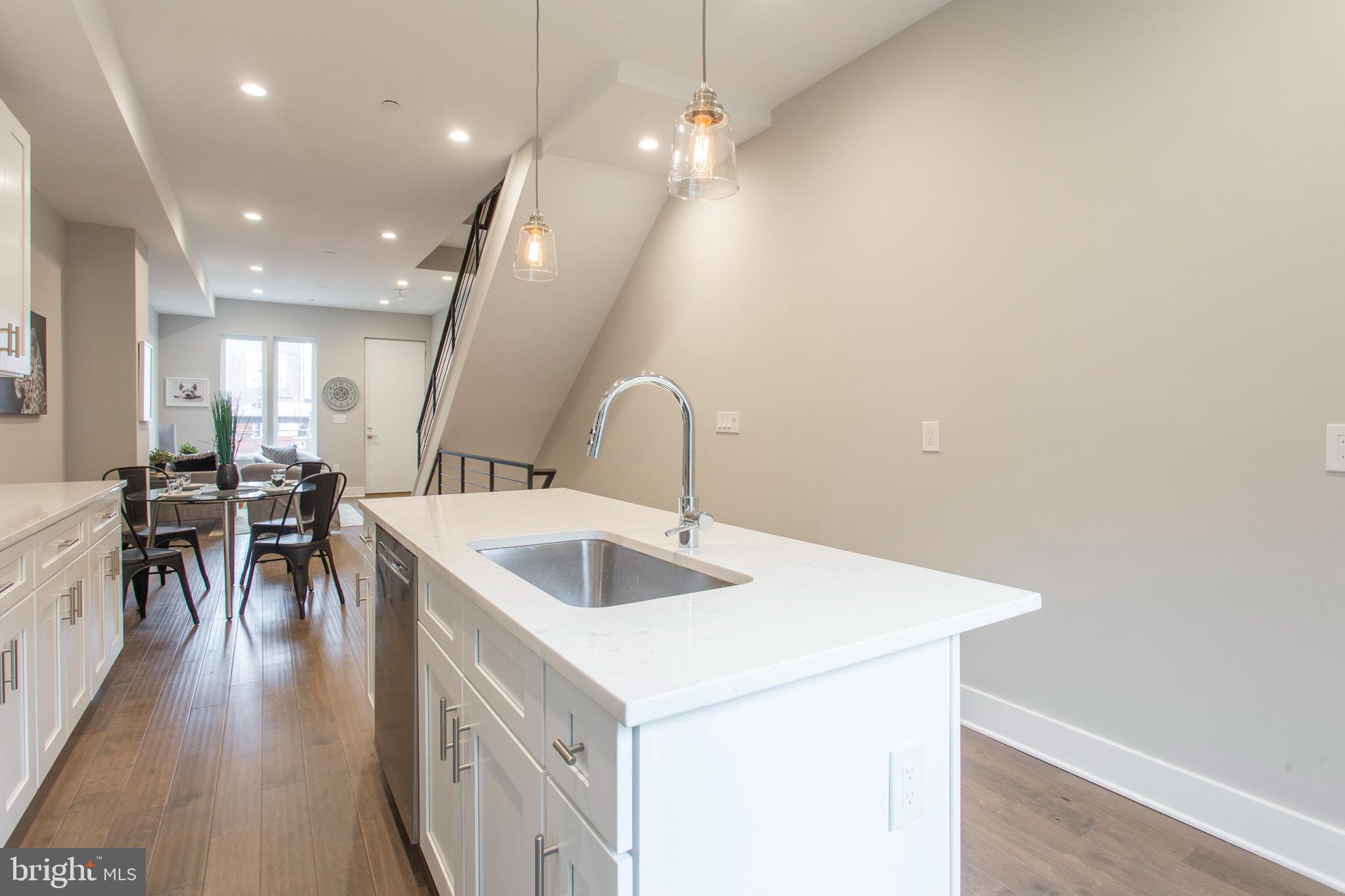 542 Pierce Street Philadelphia, PA 19148 - Photo 10 of 36 a kitchen with a sink appliances and a dining table