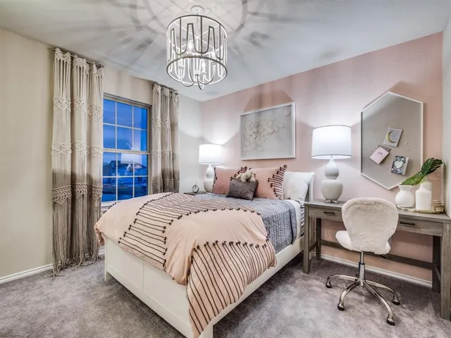 a bedroom with bed and a chandelier