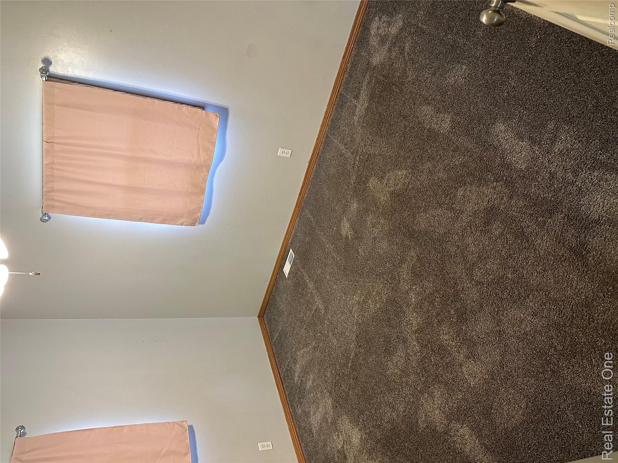 2430 Coolidge Road Barryton, MI 49305 - Photo 15 of 29 Neutral wall paint with wood trim, ceiling fan, and carpeted flooring