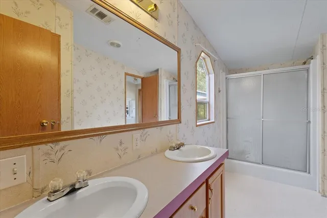 a bathroom with a sink and a mirror