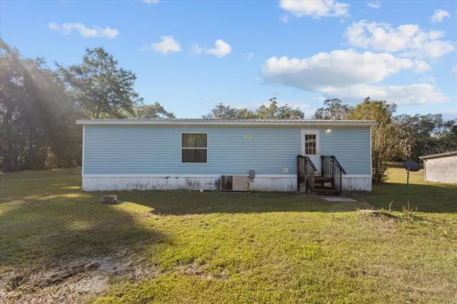 a view of a house with a yard and sitting area