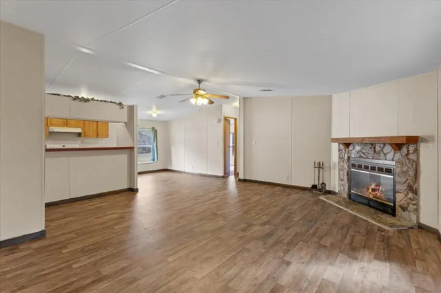 a view of a kitchen with a sink a dishwasher and a fireplace