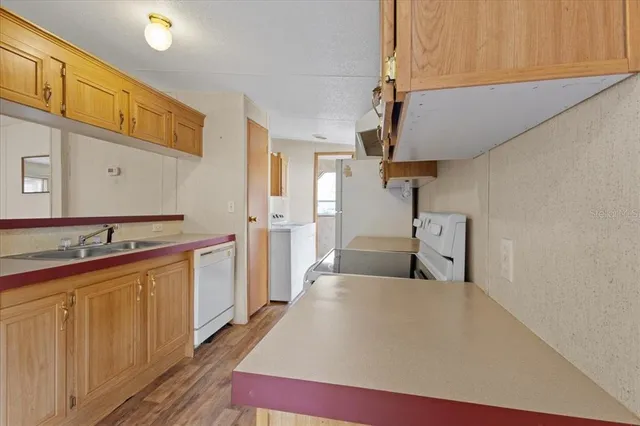 a kitchen with cabinets a sink and appliances