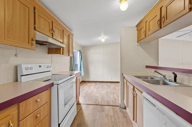 a kitchen with stainless steel appliances granite countertop a sink and cabinets