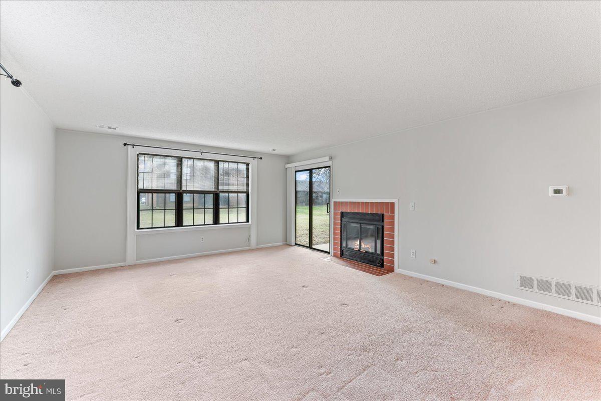 44 Witherspoon Court, Unit 137 Chesterbrook, PA 19087 - Photo 12 of 26 an empty room with windows and fireplace