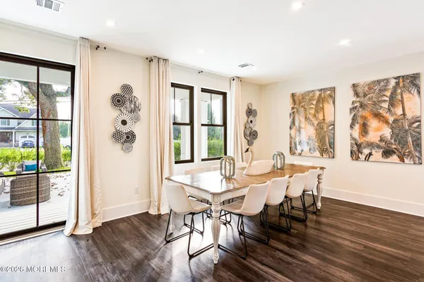 a view of a dining room with furniture large window and wooden floor