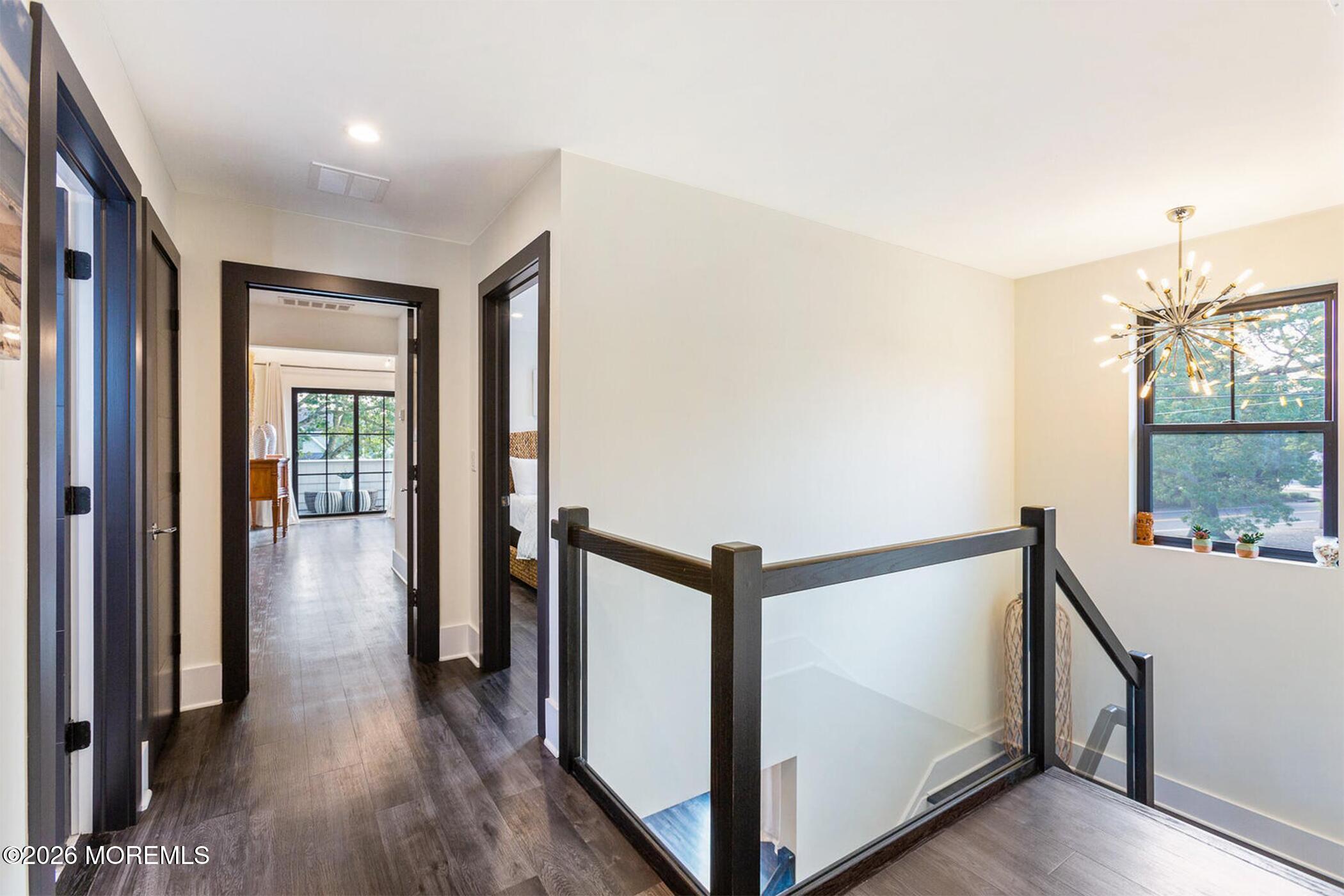 1320 Charles Street Point Pleasant, NJ 08742 - Photo 15 of 41 a view of a hallway with wooden floor and staircase