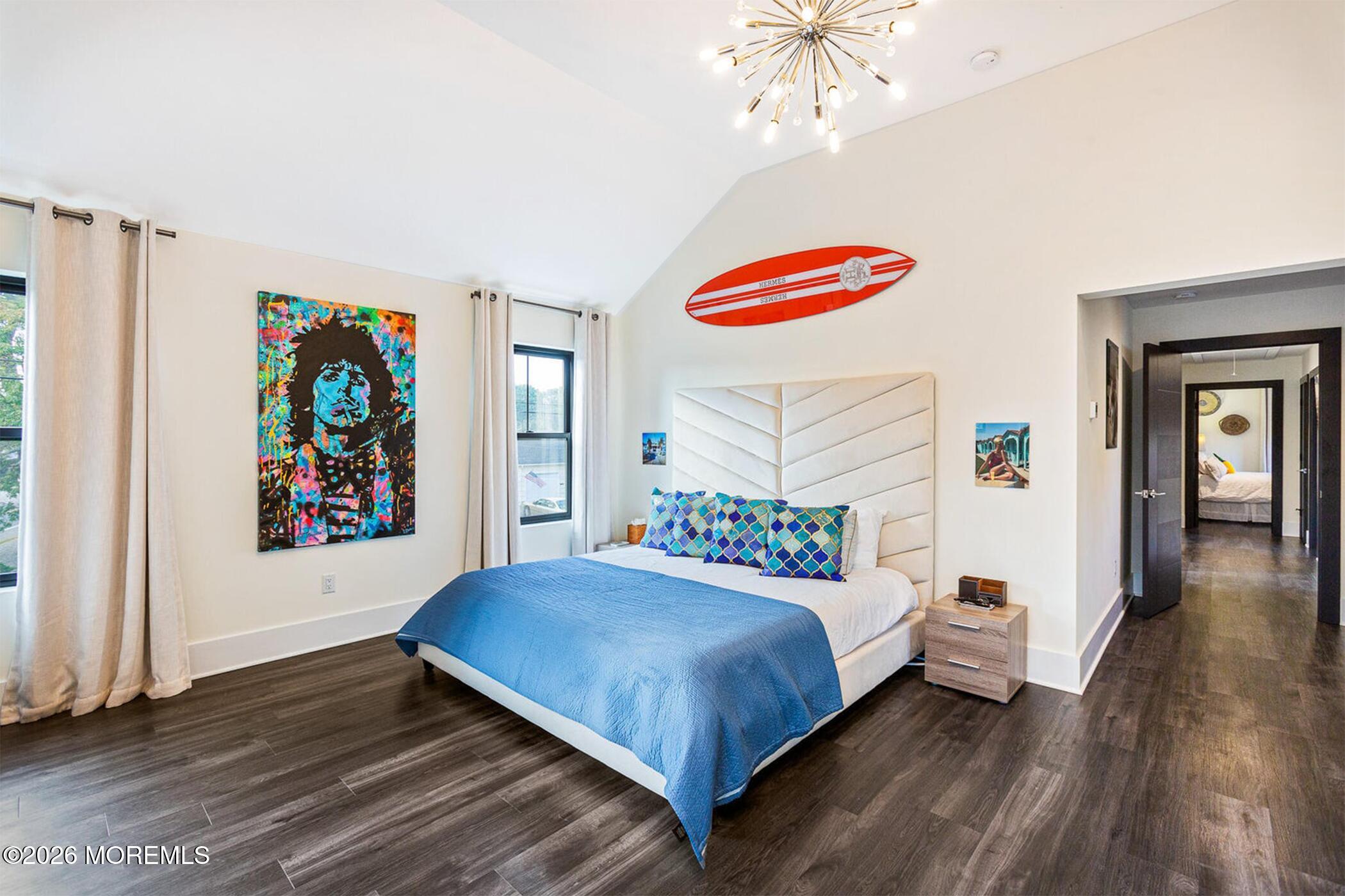 1320 Charles Street Point Pleasant, NJ 08742 - Photo 16 of 41 a bedroom with a bed and a chandelier