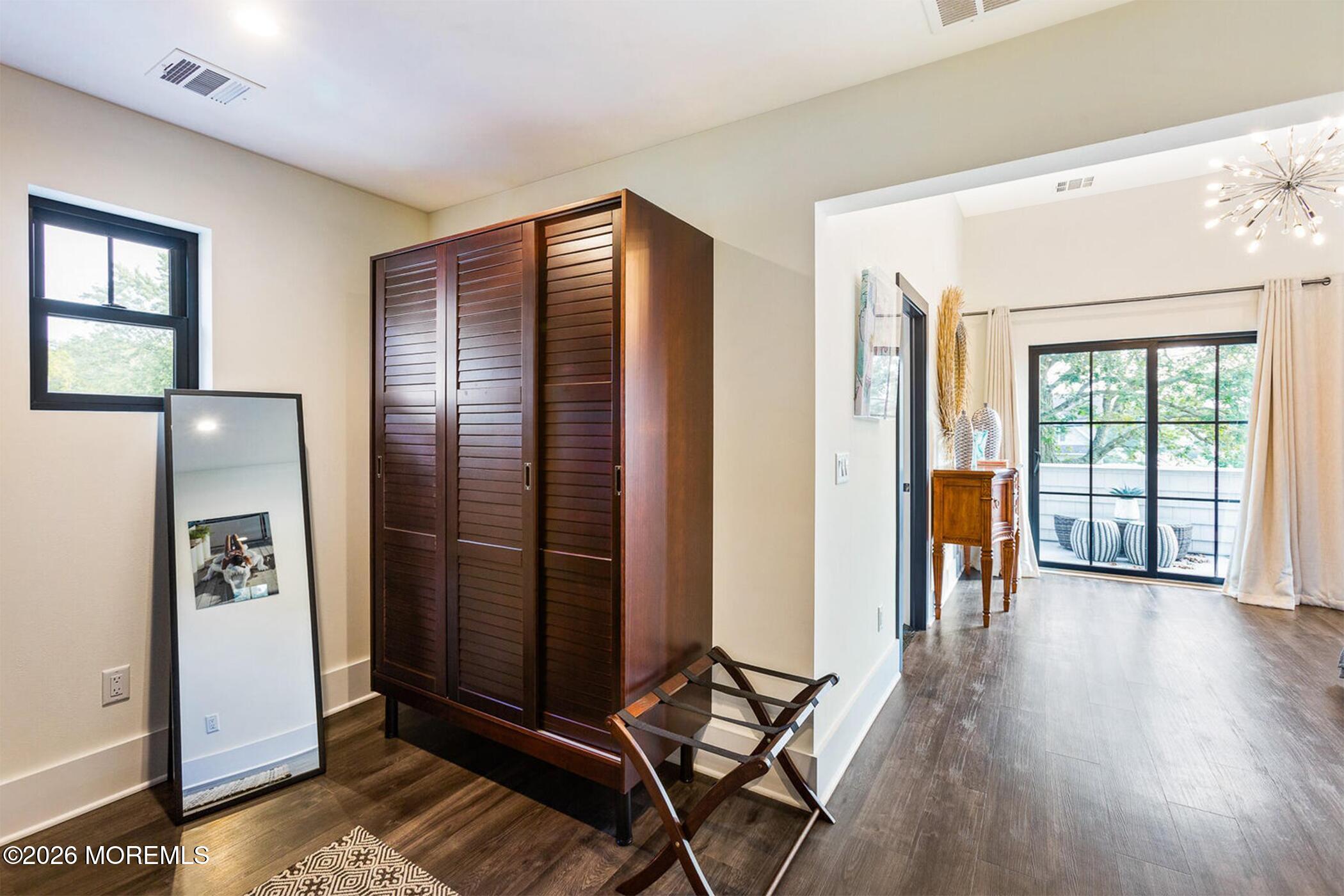 1320 Charles Street Point Pleasant, NJ 08742 - Photo 19 of 41 a view of a hallway with wooden floor and windows