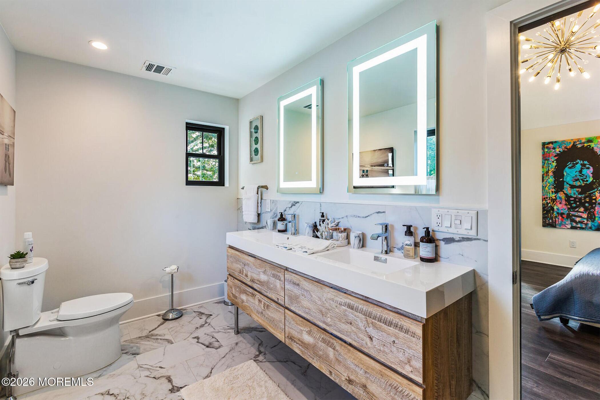 1320 Charles Street Point Pleasant, NJ 08742 - Photo 23 of 41 a bathroom with a sink mirror vanity and toilet