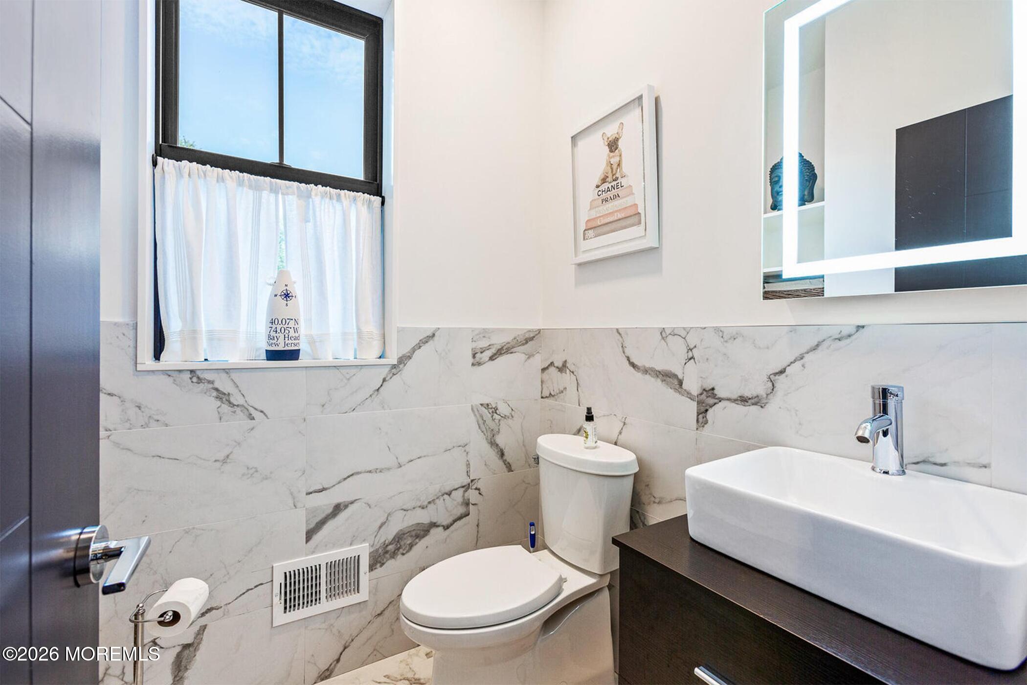 1320 Charles Street Point Pleasant, NJ 08742 - Photo 25 of 41 a bathroom with a sink toilet and mirror