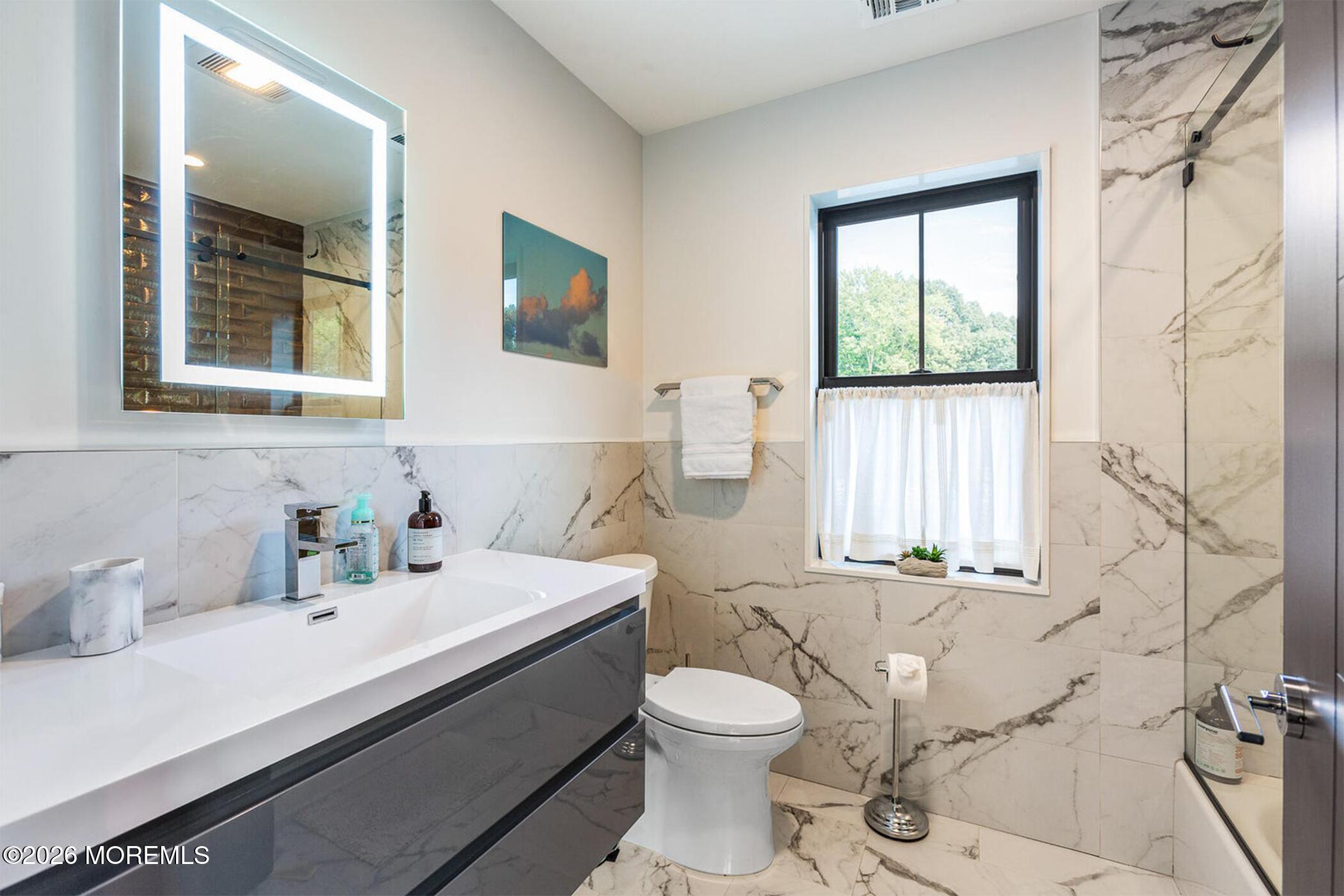 1320 Charles Street Point Pleasant, NJ 08742 - Photo 26 of 41 a bathroom with a sink toilet and mirror