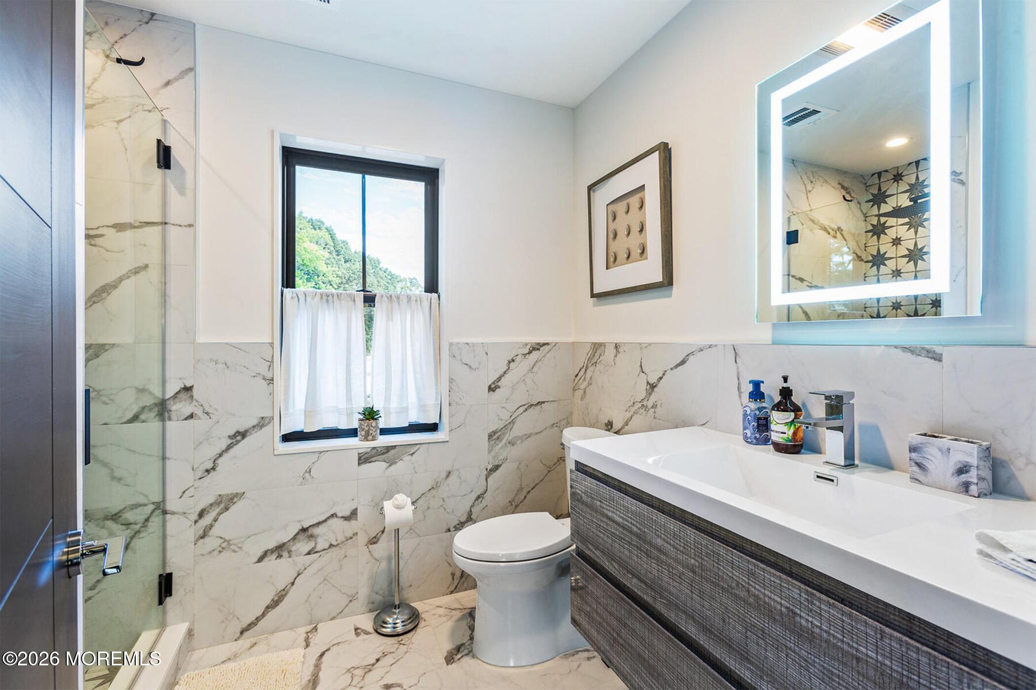1320 Charles Street Point Pleasant, NJ 08742 - Photo 27 of 41 a bathroom with a sink a toilet and shower