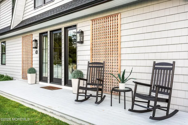 a view of chair and tables in the back yard of the house