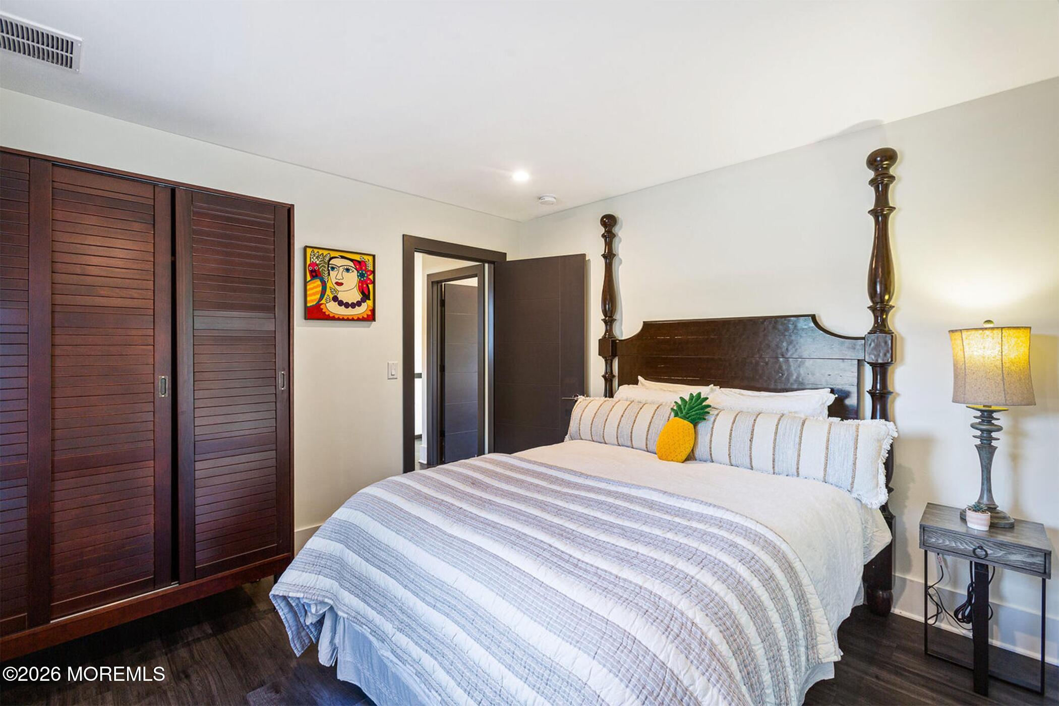 1320 Charles Street Point Pleasant, NJ 08742 - Photo 31 of 41 a bedroom with a bed and wooden floor