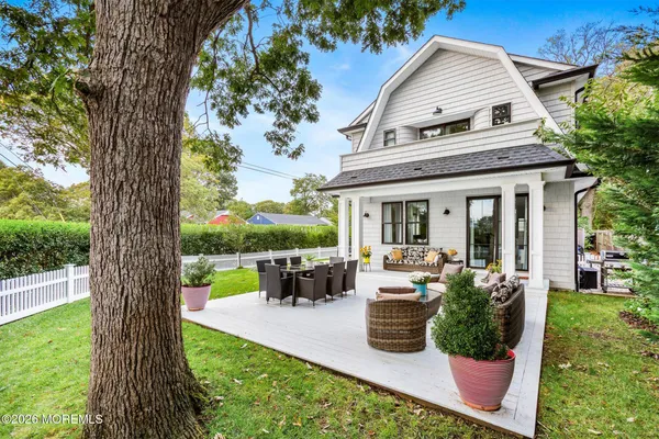 a view of a house with backyard sitting area and garden