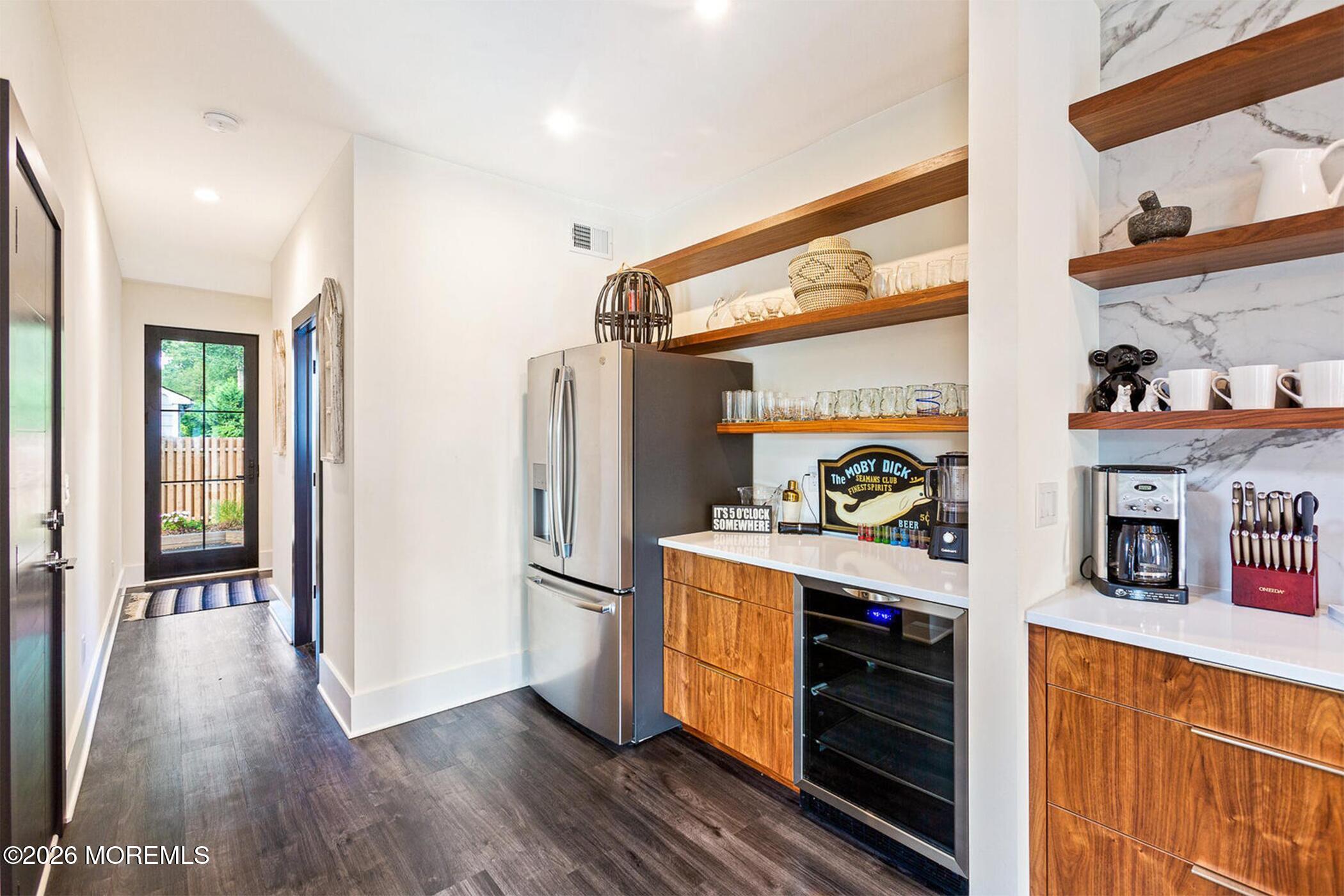 1320 Charles Street Point Pleasant, NJ 08742 - Photo 6 of 41 a kitchen with stainless steel appliances a refrigerator and a wooden floor
