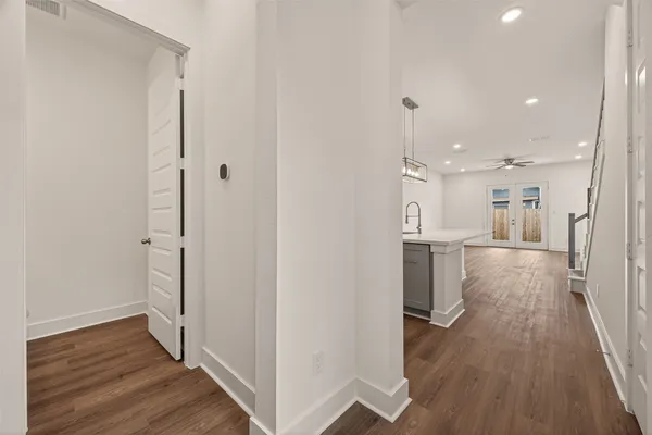 a view of a hallway with wooden floor