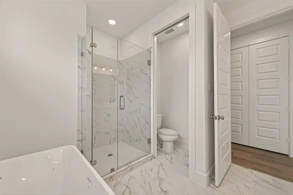 a bathroom with a shower a toilet and a shower