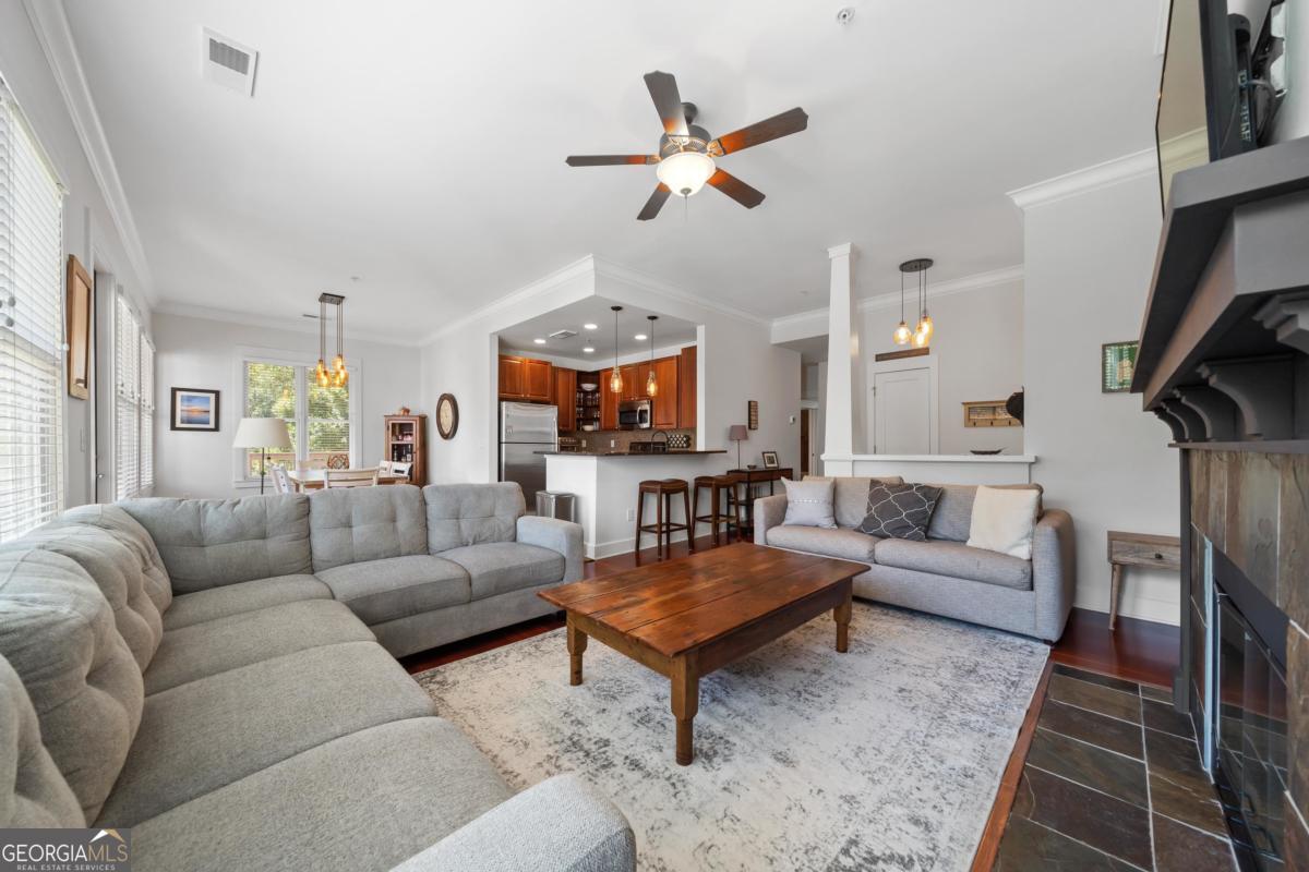 129 South Bay Road Eatonton, GA 31024 - Photo 11 of 45 a living room with furniture a fireplace and a chandelier