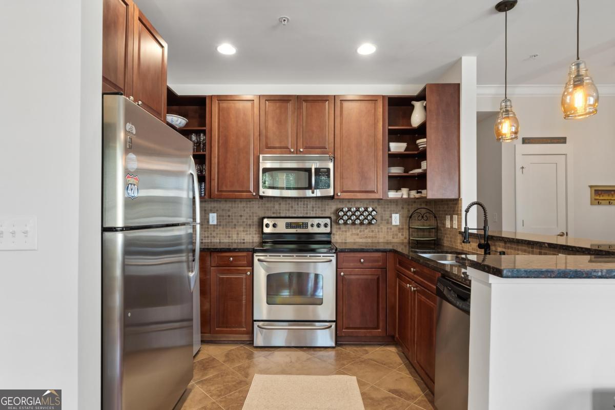 129 South Bay Road Eatonton, GA 31024 - Photo 13 of 45 a kitchen with a sink stainless steel appliances and cabinets