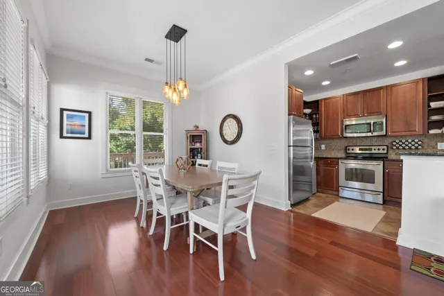 a view of a dining room with furniture window and wooden floor