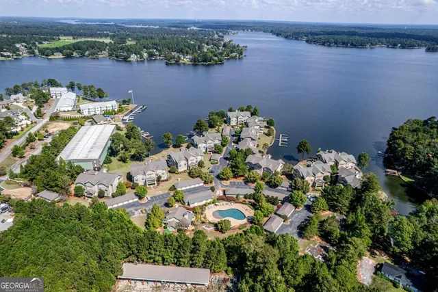 an aerial view of a house with a yard and lake view