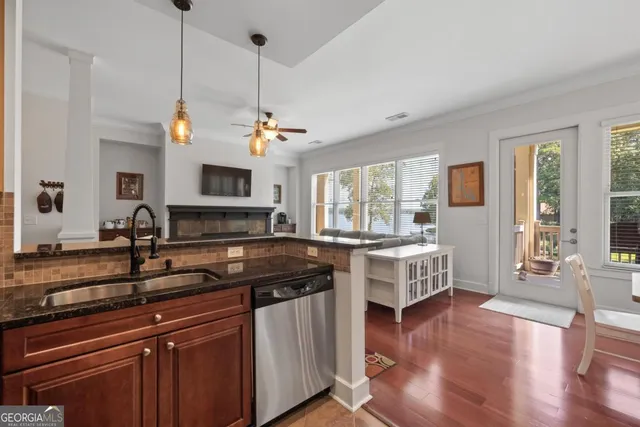 a dining room with furniture a chandelier and wooden floor