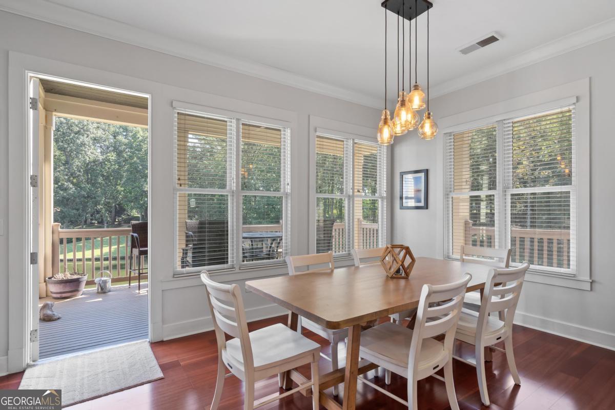129 South Bay Road Eatonton, GA 31024 - Photo 22 of 45 a dining room with furniture a chandelier and wooden floor