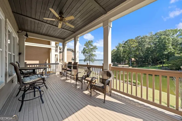 a kitchen with stainless steel appliances kitchen island granite countertop a table chairs and a refrigerator