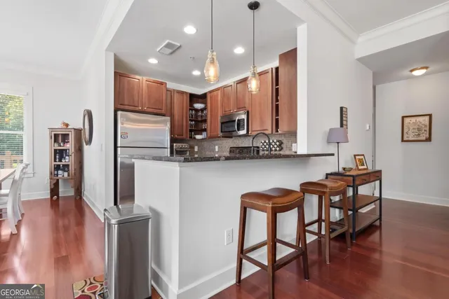 a dinning room and kitchen with a table chairs