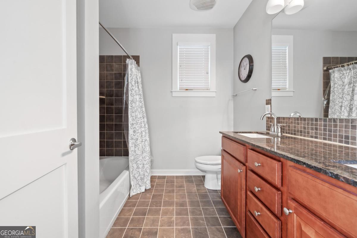 129 South Bay Road Eatonton, GA 31024 - Photo 34 of 45 a bathroom with a sink a toilet a shower and a mirror