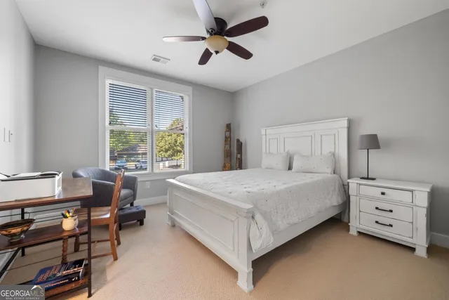 a bedroom with furniture and a ceiling fan