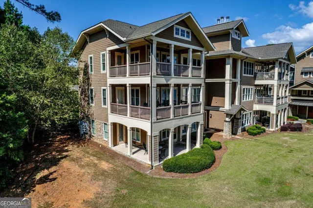 an aerial view of a houses with a lake view
