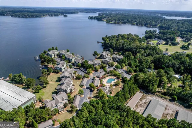 an aerial view of a house with a garden and lake view