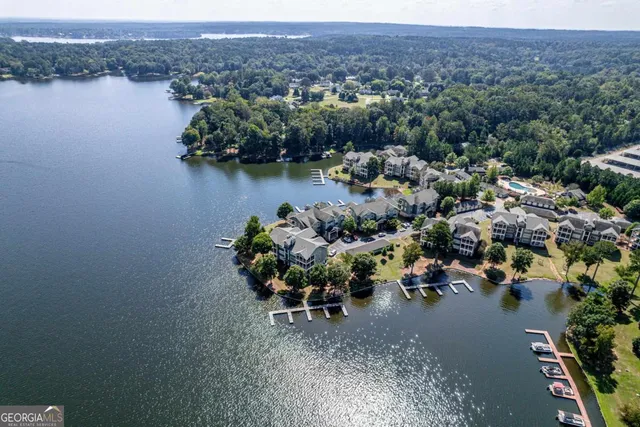 an aerial view of a house with a yard and lake view in back