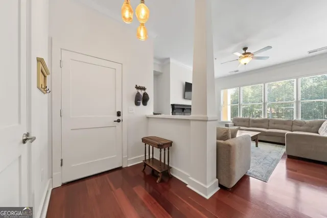 a living room with furniture a flat screen tv and a fireplace