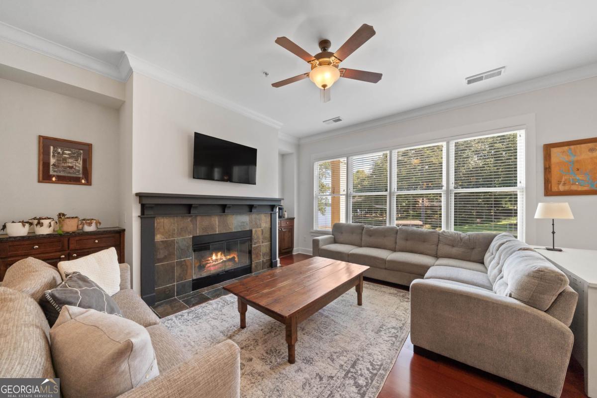 129 South Bay Road Eatonton, GA 31024 - Photo 9 of 45 a living room with furniture a flat screen tv and a fireplace